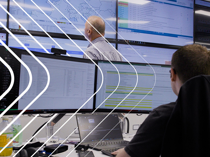 people working at screens, network defense, feature