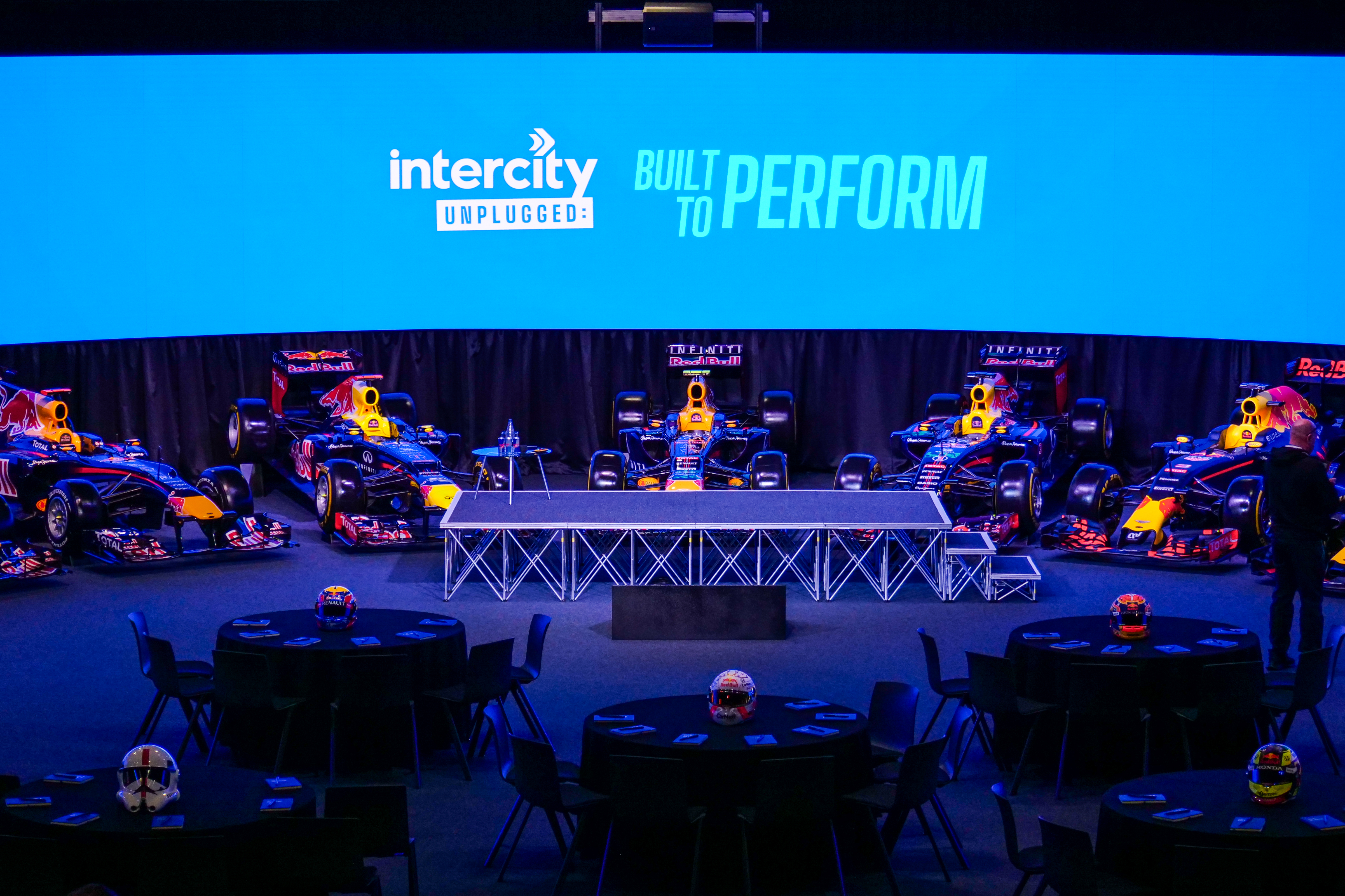 Intercity Unplugged - Built to Perform event stage surrounded by racing cars
